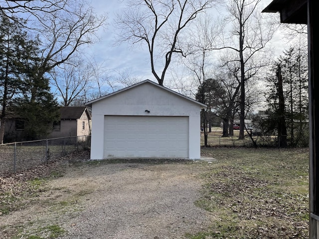 detached garage featuring fence