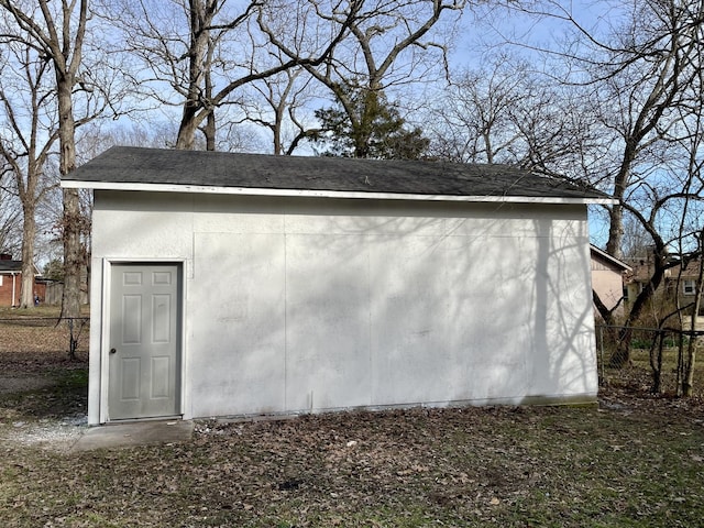 view of outbuilding with an outbuilding and fence