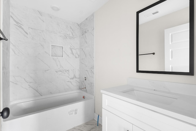 bathroom with vanity and tiled shower / bath combo