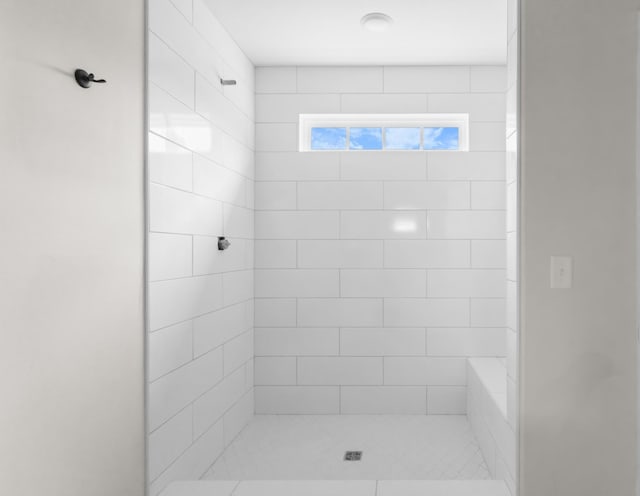 bathroom with a tile shower