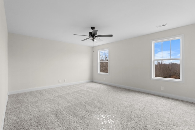 carpeted spare room with ceiling fan