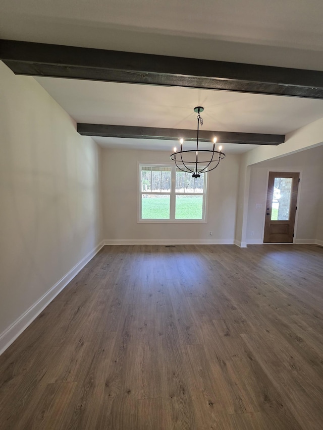 unfurnished dining area with plenty of natural light, dark wood-style floors, baseboards, and an inviting chandelier