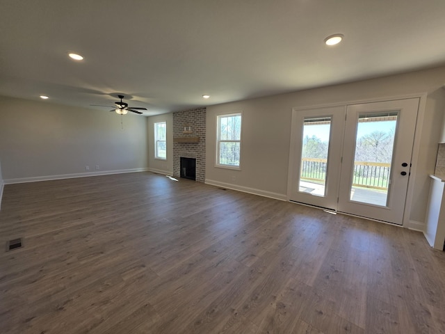 unfurnished living room with visible vents, baseboards, a ceiling fan, dark wood finished floors, and recessed lighting