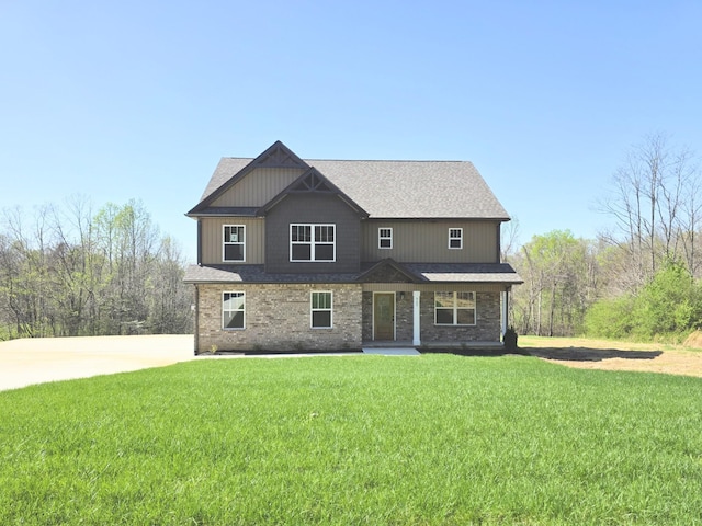 craftsman inspired home with brick siding and a front lawn