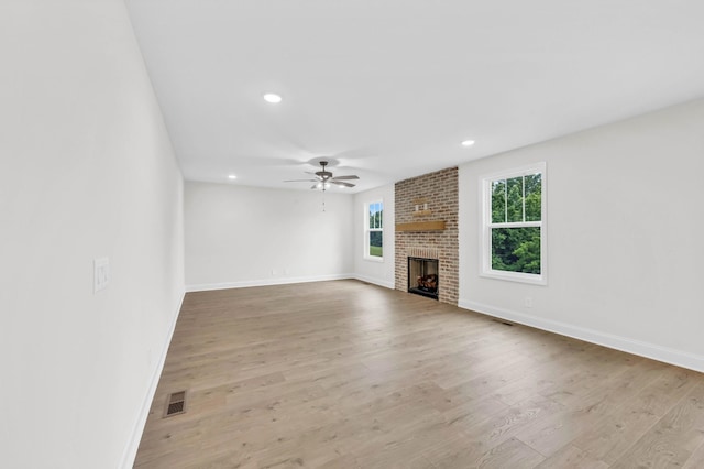 965 Palmyra Rd, Clarksville, TN 37040 - unfurnished living room with ceiling fan, a brick fireplace, wood finished floors, baseboards, and recessed lighting