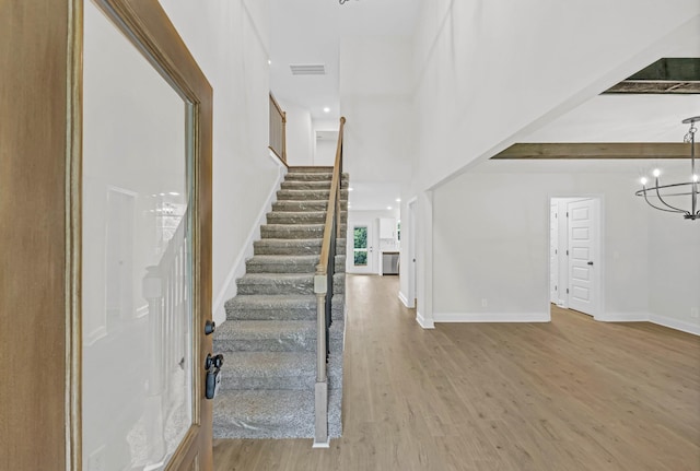 965 Palmyra Rd, Clarksville, TN 37040 - stairway featuring a chandelier, wood finished floors, baseboards, and a towering ceiling