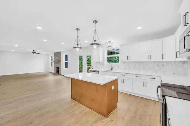 965 Palmyra Rd, Clarksville, TN 37040 - kitchen featuring recessed lighting, a kitchen island, decorative backsplash, white cabinets, and light wood finished floors