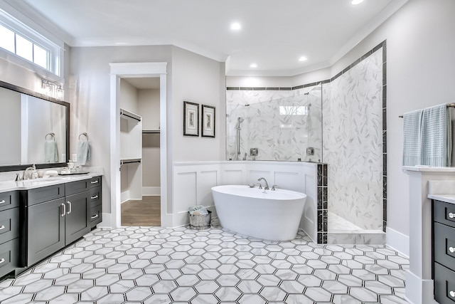 bathroom with vanity, ornamental molding, and independent shower and bath