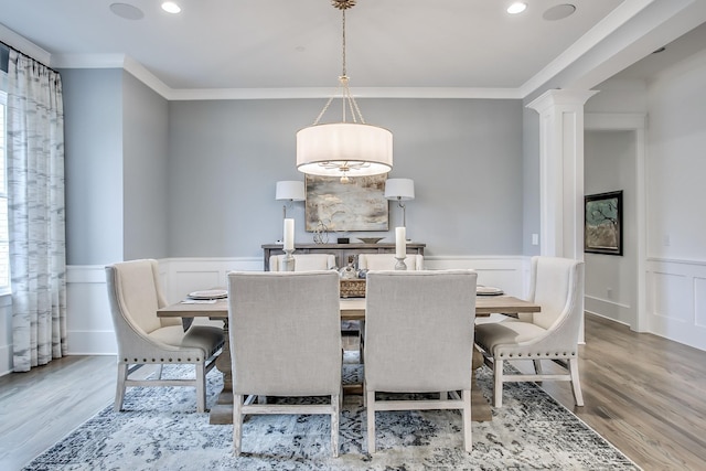 dining room featuring crown molding and light hardwood / wood-style flooring