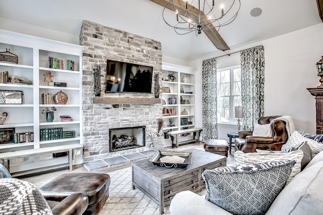 living room with beam ceiling, a chandelier, and a stone fireplace