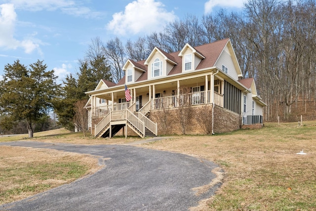 cape cod-style house with a porch, central AC unit, and a front lawn