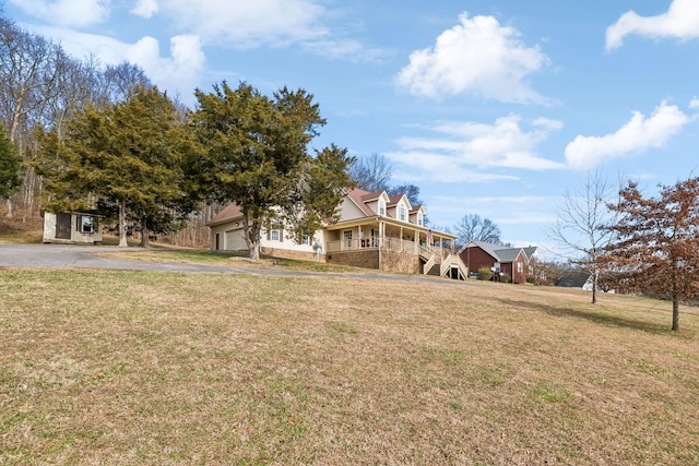 view of front facade with covered porch, a front lawn, and a garage