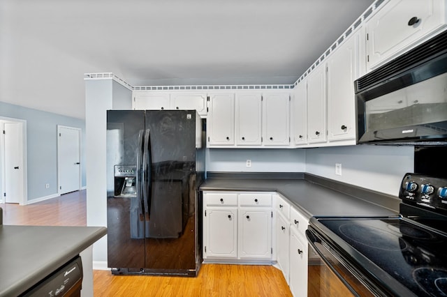 kitchen with light hardwood / wood-style floors, white cabinets, and black appliances