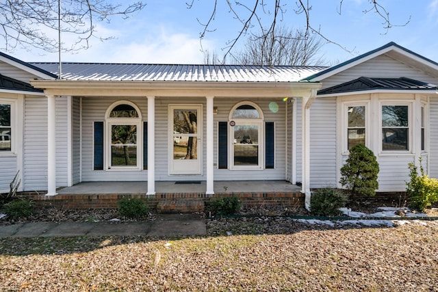 view of exterior entry featuring a porch