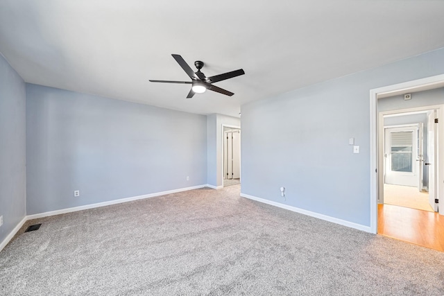 carpeted spare room featuring ceiling fan