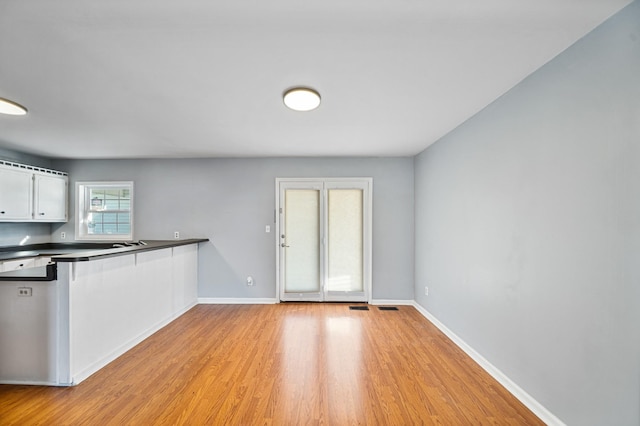 kitchen featuring white cabinets and light hardwood / wood-style flooring