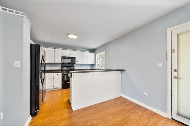 kitchen with black appliances, light hardwood / wood-style floors, white cabinets, and kitchen peninsula