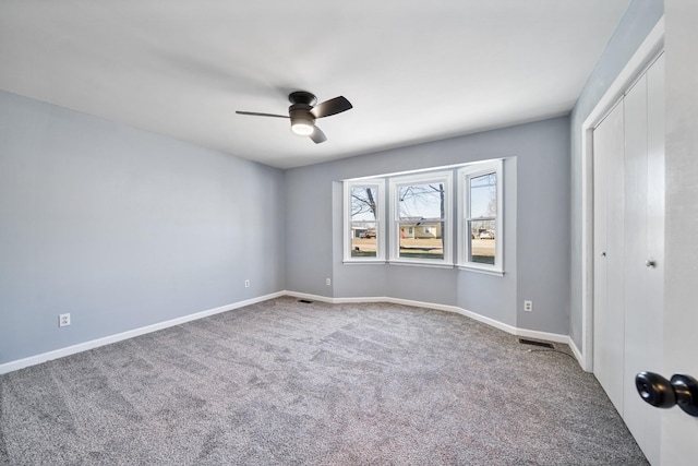 carpeted empty room with ceiling fan