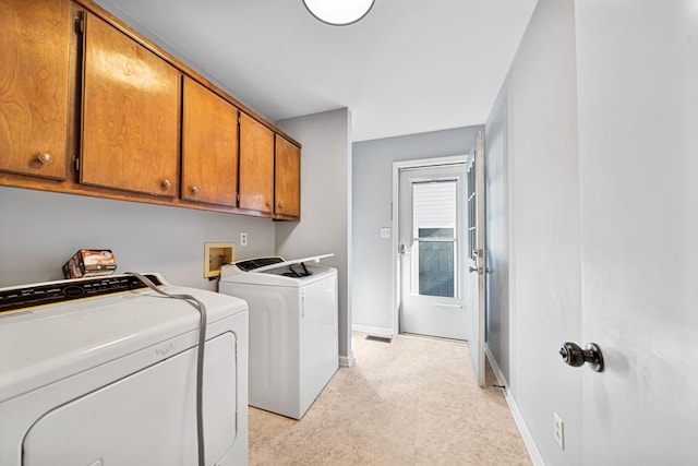 laundry area with cabinets and separate washer and dryer