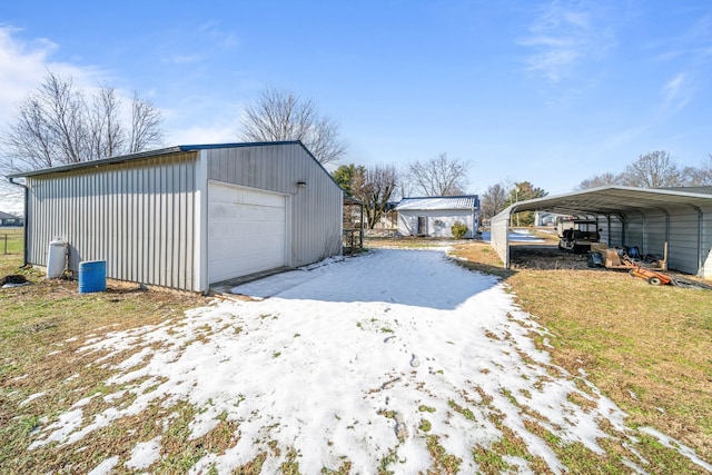 garage featuring a yard and a carport