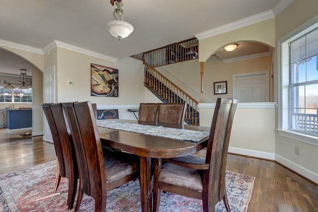 dining area featuring ornamental molding and dark hardwood / wood-style floors