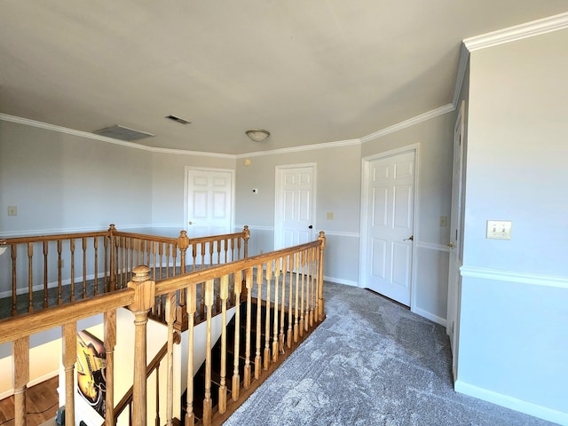 hallway featuring crown molding and dark carpet