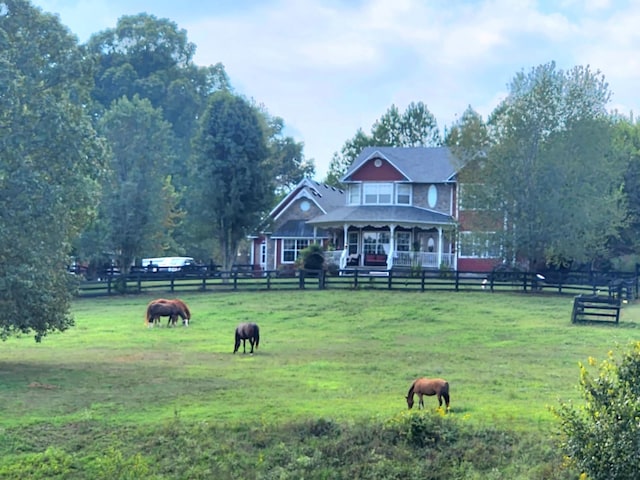 surrounding community featuring a rural view and a yard