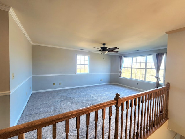 unfurnished room featuring carpet flooring, ceiling fan, and crown molding