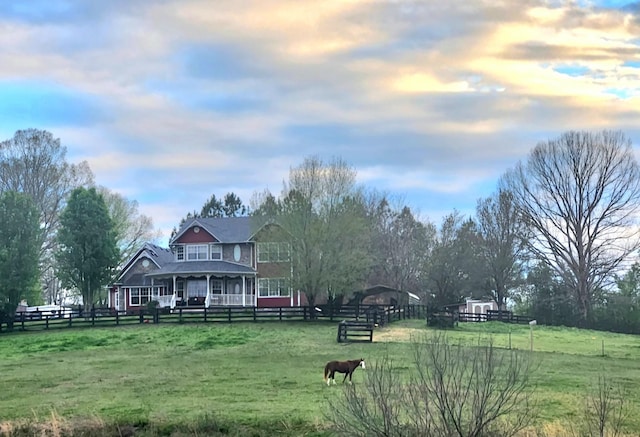 view of home's community featuring a yard and a rural view