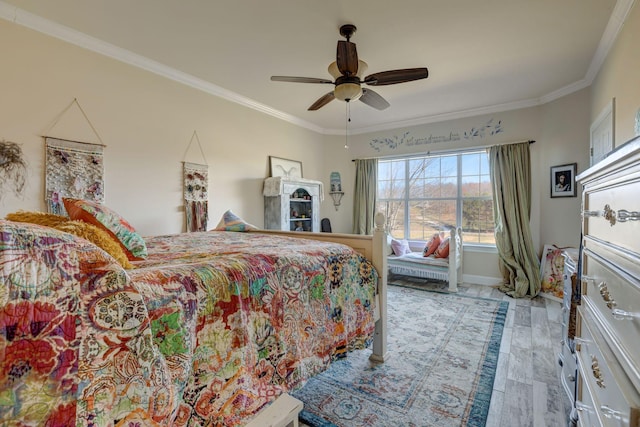 bedroom featuring light wood-type flooring, ceiling fan, and crown molding