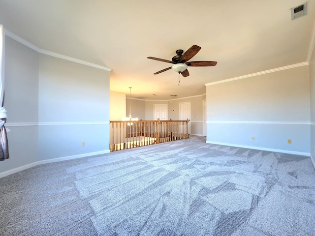 empty room featuring ceiling fan with notable chandelier, carpet floors, and crown molding