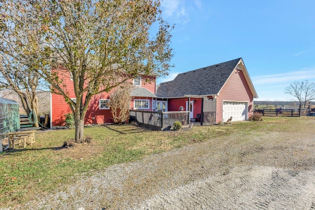 view of front of house with a garage and a front lawn