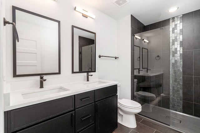 bathroom with vanity, an enclosed shower, and toilet