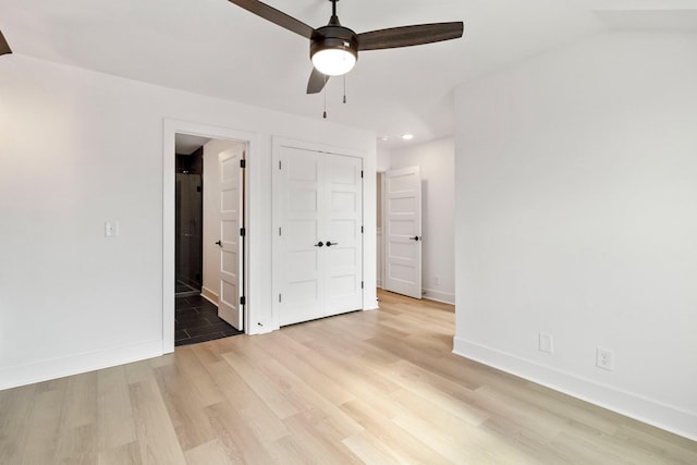 unfurnished bedroom with connected bathroom, ceiling fan, and light hardwood / wood-style flooring