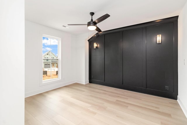 unfurnished bedroom with light hardwood / wood-style floors and ceiling fan