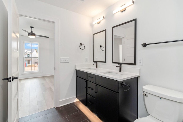 bathroom with ceiling fan, vanity, toilet, and tile patterned floors