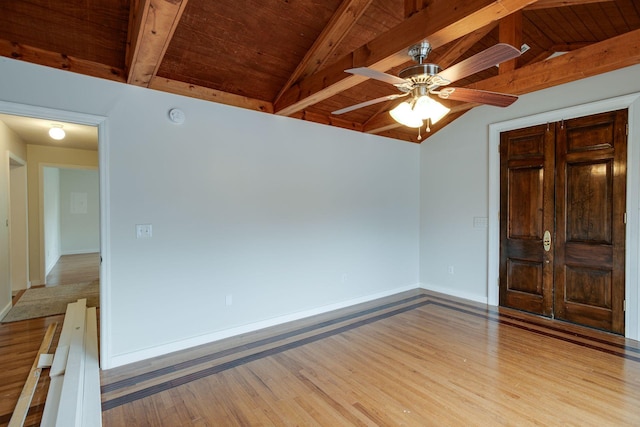 spare room featuring ceiling fan, wood ceiling, light wood-type flooring, and vaulted ceiling with beams