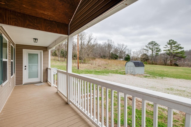 wooden terrace with a storage shed