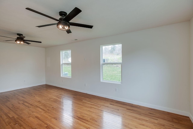 unfurnished room with ceiling fan and light wood-type flooring