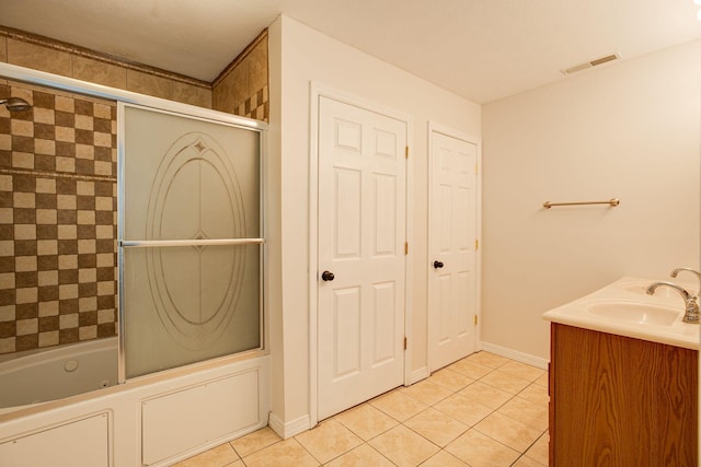 bathroom with vanity, tile patterned flooring, and shower / bath combination with glass door