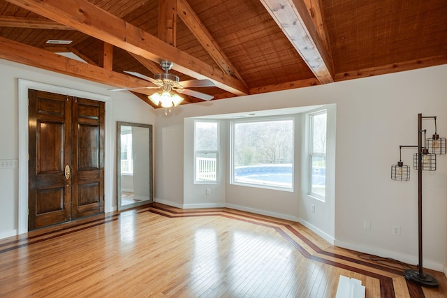 interior space featuring ceiling fan, light hardwood / wood-style flooring, wood ceiling, and vaulted ceiling with beams