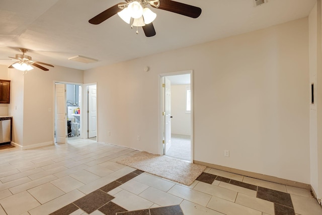 tiled spare room with ceiling fan