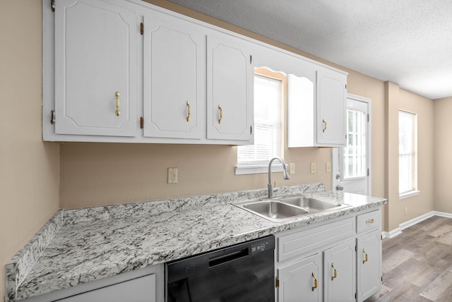 kitchen with a textured ceiling, dishwasher, light hardwood / wood-style floors, white cabinets, and sink