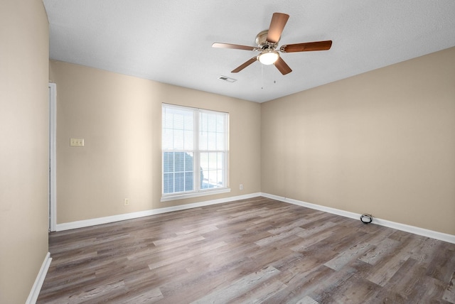 spare room with ceiling fan and light hardwood / wood-style flooring