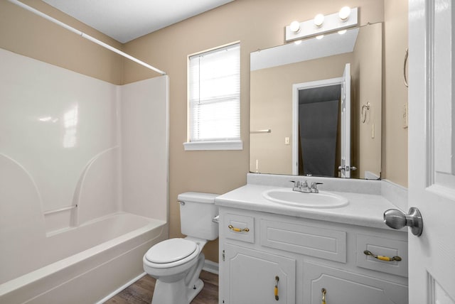 full bathroom with wood-type flooring, bathing tub / shower combination, vanity, and toilet