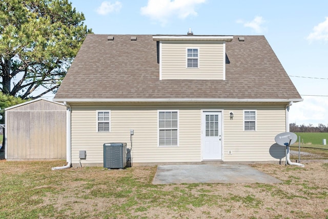 back of house featuring cooling unit, a yard, and a patio