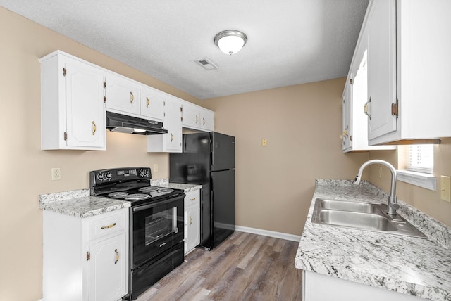 kitchen with black appliances, white cabinets, a textured ceiling, and sink