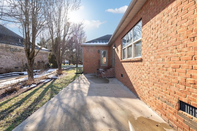 view of property exterior with a patio area