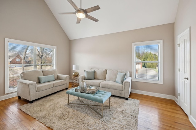 living room with high vaulted ceiling, ceiling fan, and hardwood / wood-style floors