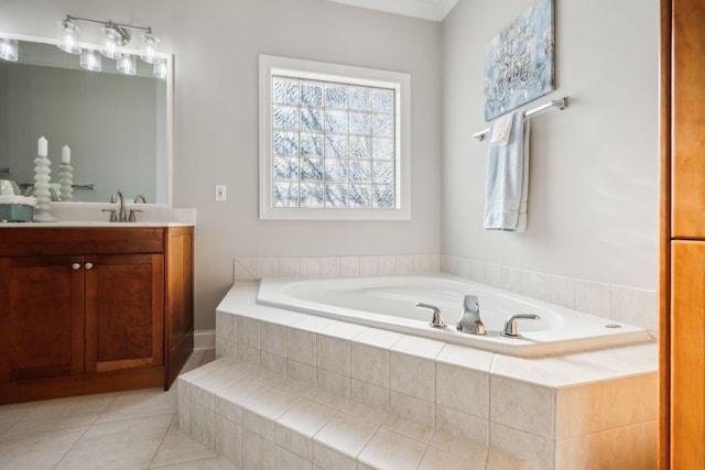 bathroom featuring tile patterned flooring, tiled tub, and vanity